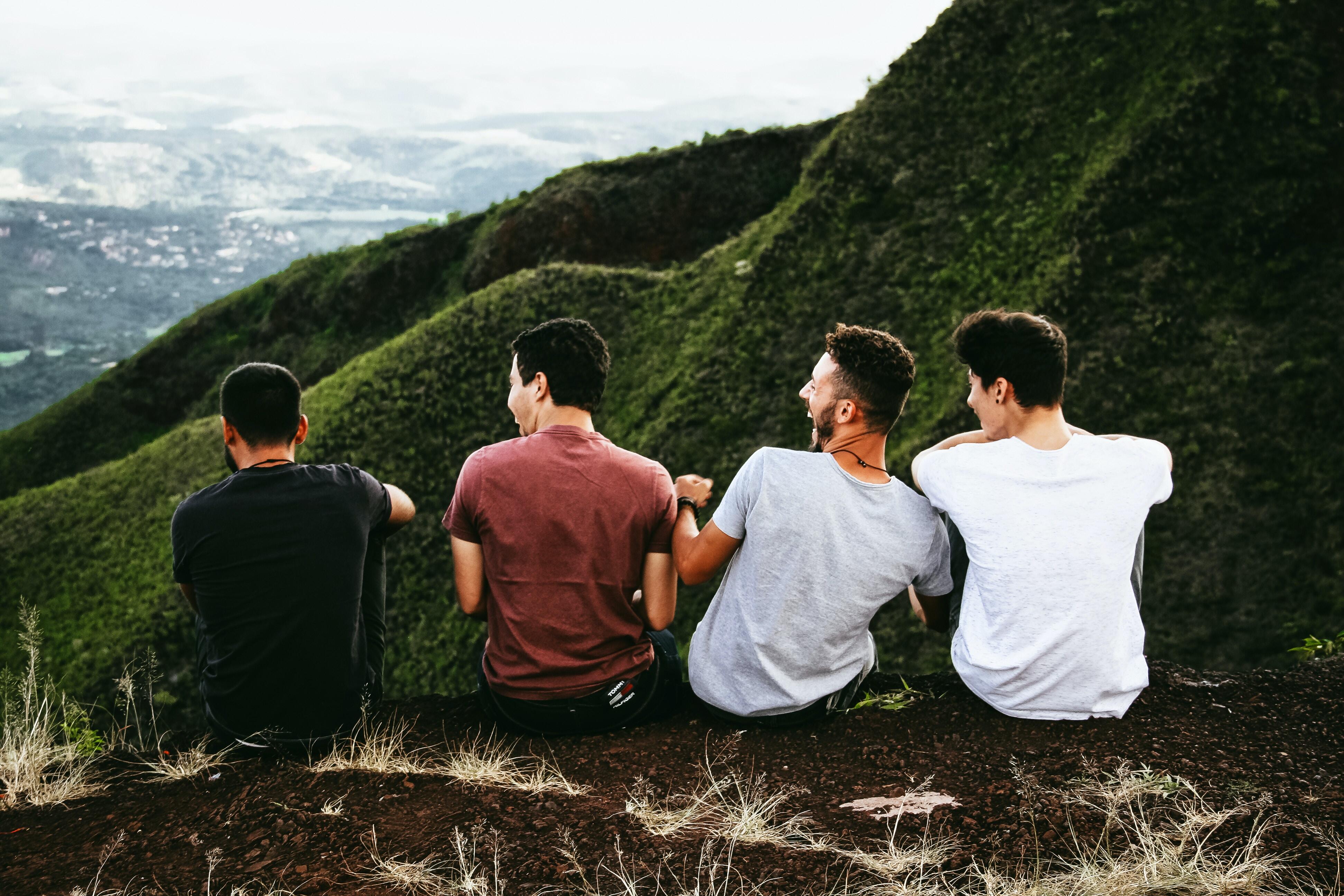 Four friends sitting together and laughing